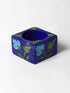 Turquoise Flower With Green Leaves on Blue Base